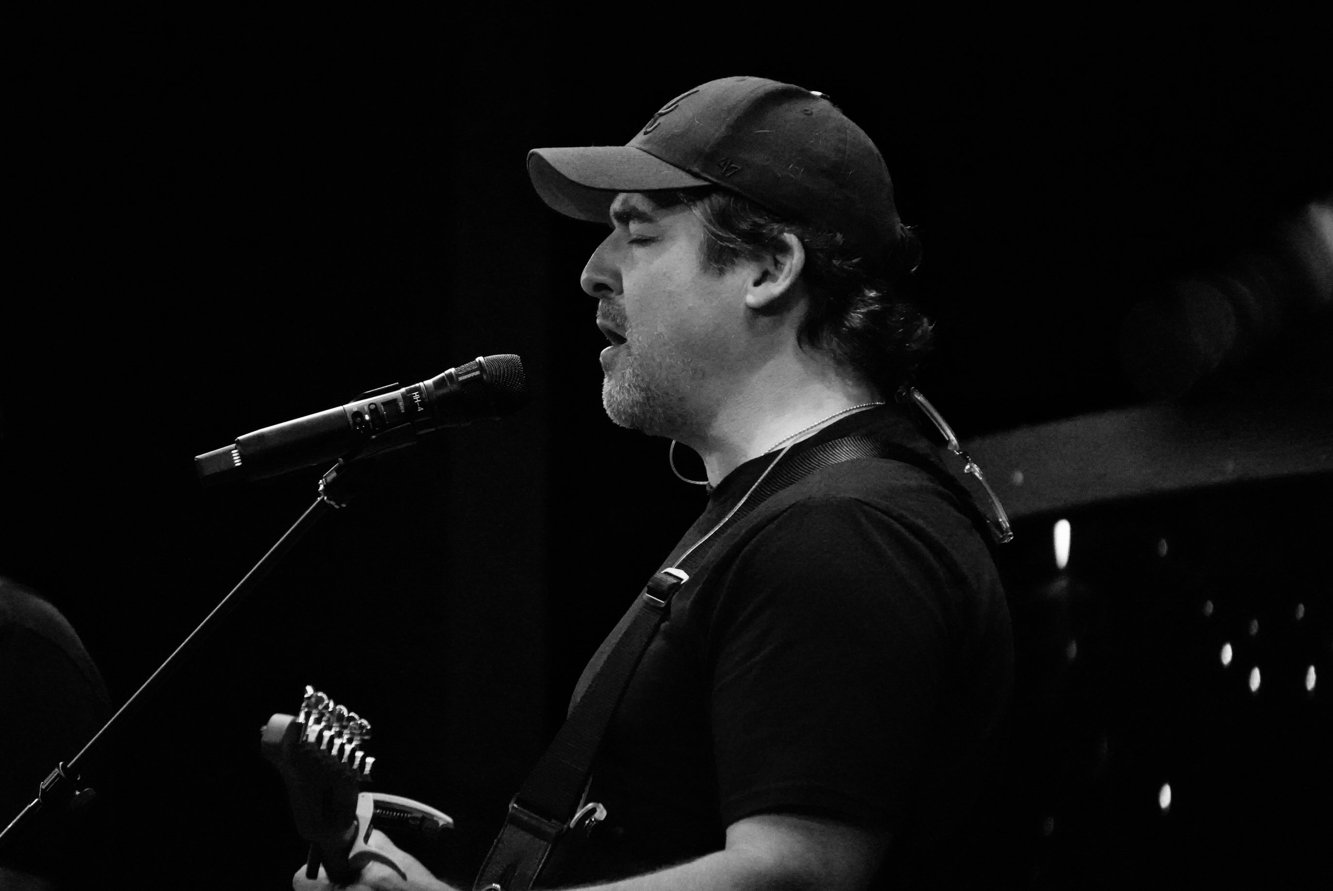 Down for Now guitarist singing during a live performance